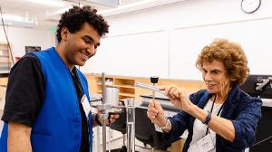 SMC student James Turkson and SMC trustee Dr. Nancy Greenstein explore the physics of sound through a hands-on experiment measuring the speed of sound in air. [Photo Credit: Keats Elliott / Santa Monica College Foundation]