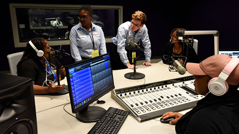 students gathered around equipment