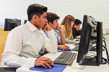 Three students in a computer lab at SMC's Center for Media and Design during a cloud computing class.