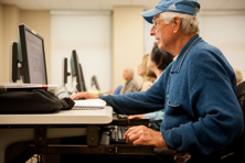 Man looking and computer and typing.