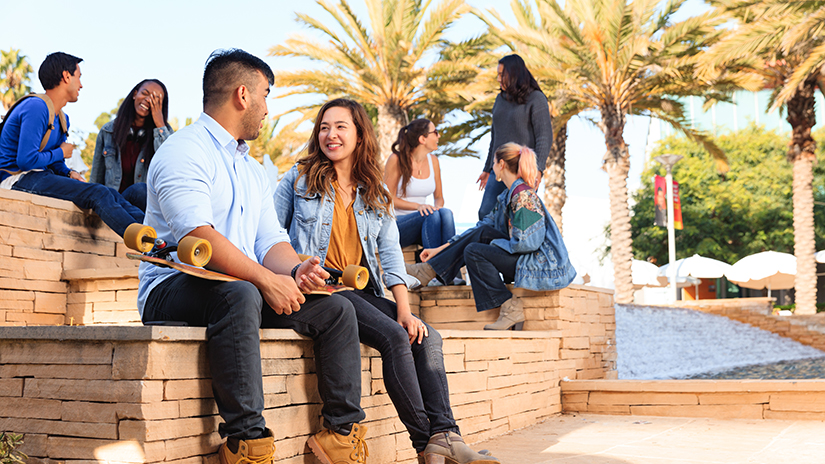 SMC students sitting by fountain