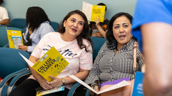 two female adult studnts at an info session