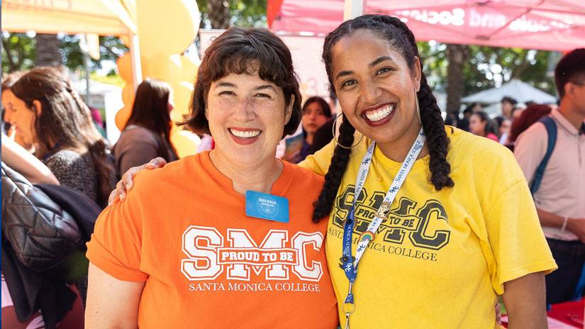 Two faculty members wearing  SMC t-shirts.