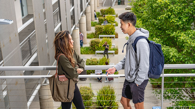 Two students talking outside Science Building