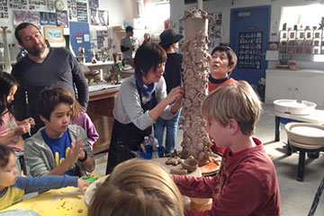 SMC Ceramic Arts students working with children