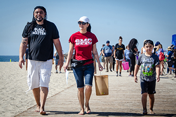 SMC Professor Dr. Rebecca Romo with her husband and child cleaning up