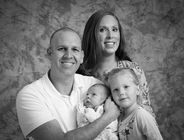 Firefighter Chris Walker, his wife Nicole, and children Eloise and Lane.