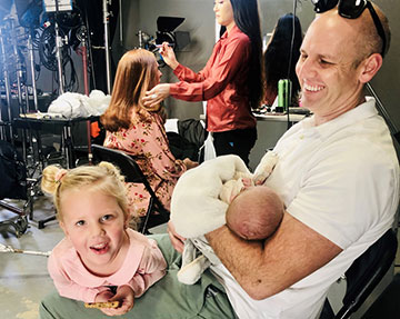 Firefighter Chris Walker and his children wait while their wife and mother, Nicole gets her makeup done