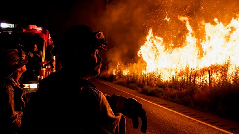 Jovan Lozano, fire Captain for the Cal Fire battalion unit out of Jurupa Valley, looks upon the Rabbit Fire as the team sits by on July 14, 2023 in Moreno Valley, Calif. The fire grew to an estimated 7,950 acres before it was contained. Photo by Jon Putnam.