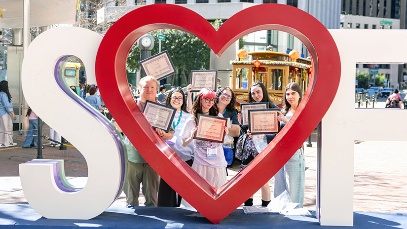 Corsair Assistant Photo Editor Tom Rosholt, Design Editor Nastassia Melendez, Editor-in-Chief Katie Easterson, Adviser Sharyn Obsatz, Arts and Entertainment Editor Kyla Downey, and Managing Editor Sofia Kieser holding Journalism Association of Community Colleges awards received by the Corsair at the Heart SF Sculpture in downtown San Francisco. (Photo Credit: Gerard Burkhart).  