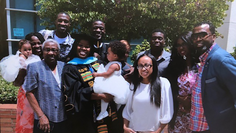 Tyffany with her family at doctoral graduation from CSUF