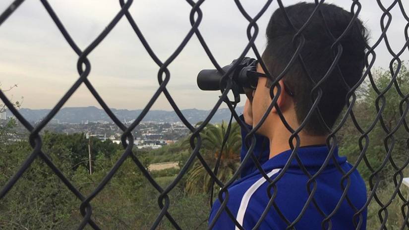 Ahmad watching birds at the Baldwin Hills Scenic Overlook.