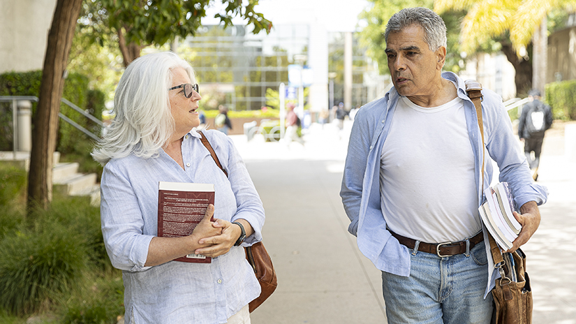 Mario Padilla and Susan Caggiano walking to class