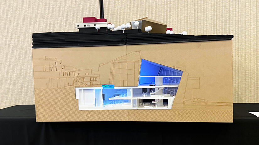 Front view of the model featuring laser-cut engraved panels and one of two embedded 3D-printed sectional reliefs; the second relief is located on an adjacent side panel.