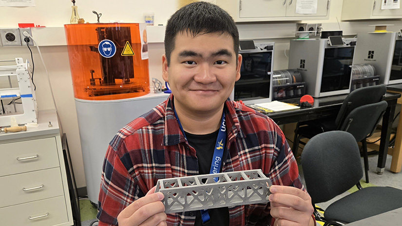 Bryan Hartanto with his bridge project during a summer program at UC Irvine