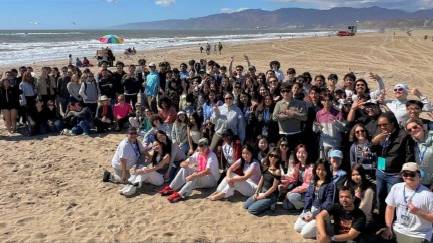 group of students sitting at the beach