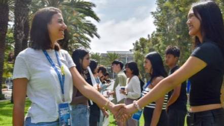 Students shaking hands and smiling