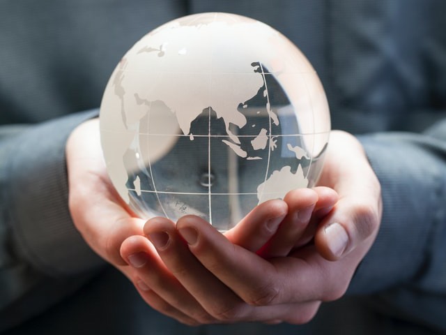 hand holding a glass globe